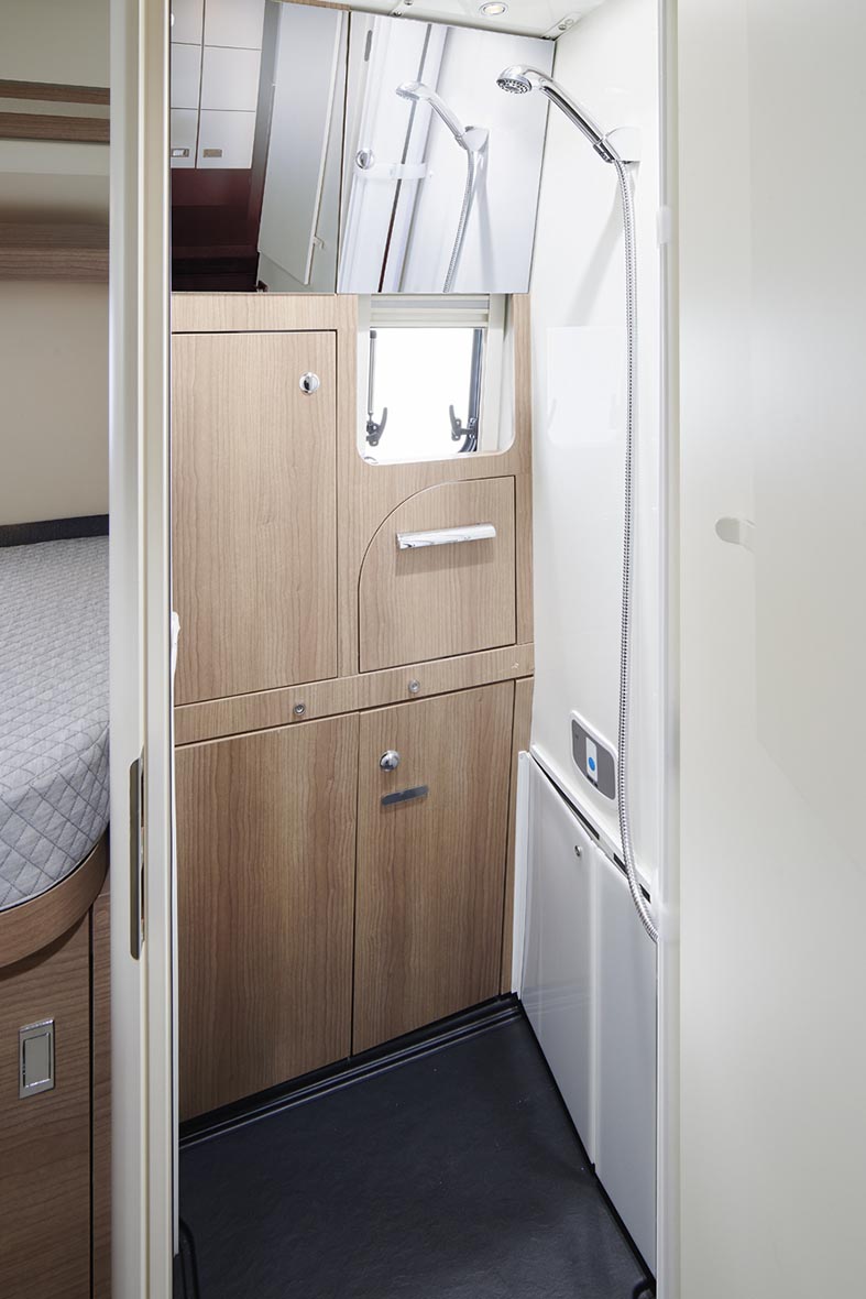 Blick in das Bad des Malibu Genius 4x4 mit Dusche, Waschbecken, Toilette und Dachfenster.